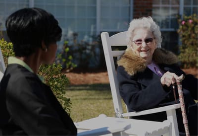 Resident enjoying time outdoors with staff member