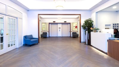 Bright lobby area with seating and elevators