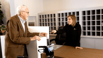 Staff assisting a resident at the reception area