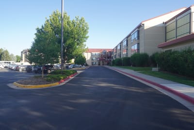 Entrance view of a senior living facility with trees