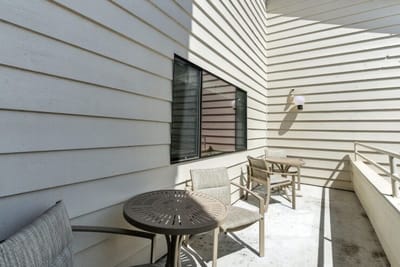 Outdoor seating area with tables and chairs.