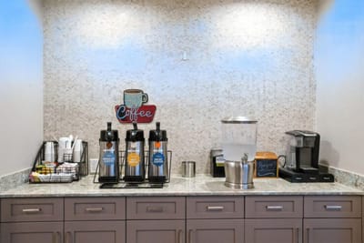 Coffee station with dispensers and snacks.