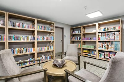 Cozy common area with bookshelves and seating.