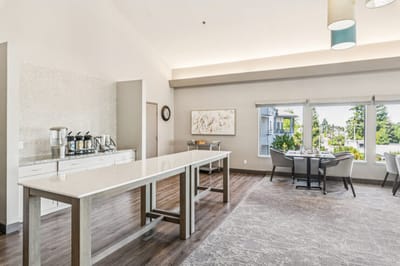 Bright common area with seating and view of outdoors.