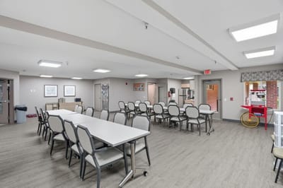 Dining area with tables and chairs in interior space.