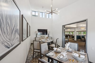 Elegant dining area with set table and modern decor.