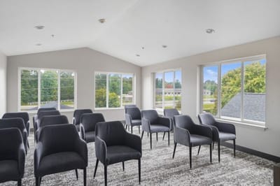 Bright interior common area with chairs arranged for an event.