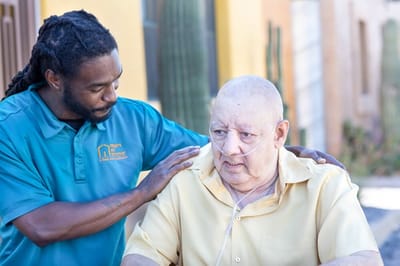 Staff assisting a senior resident outdoors