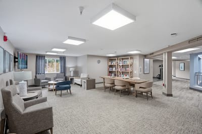 Bright, inviting common area with seating and bookshelves.