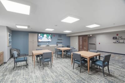 Interior common area with tables and TV.