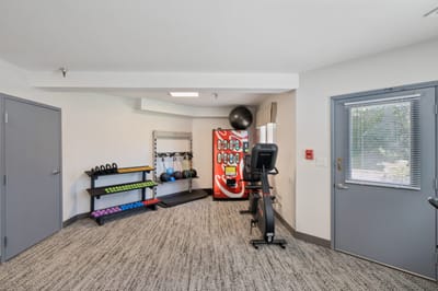 Interior view of a fitness room with exercise equipment.