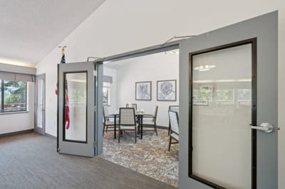 Common area with dining table and artwork.