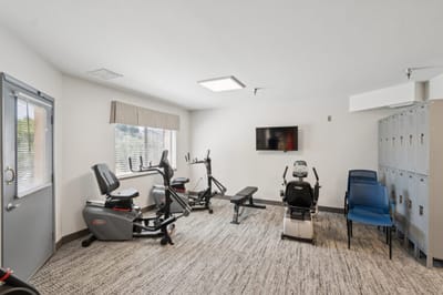 Fitness area with exercise equipment and lockers.