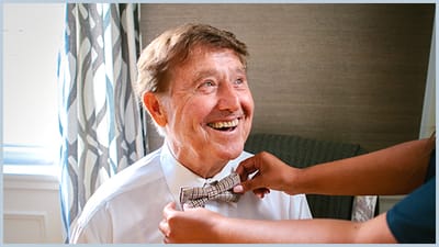 A resident getting help with a bow tie