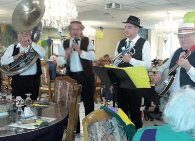 Musicians performing in a dining area full of residents
