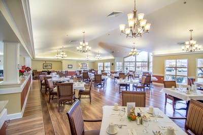 Bright dining room with tables set for meals