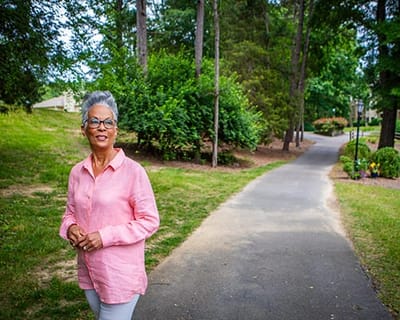 Woman walking along a scenic path in a green area