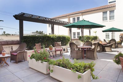 Outdoor patio area with seating and greenery
