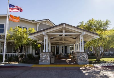 Entrance of a senior living facility with landscaping