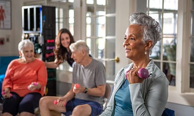 Residents exercising in a bright activity room