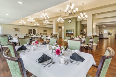 Beautifully set dining room with tables and flowers