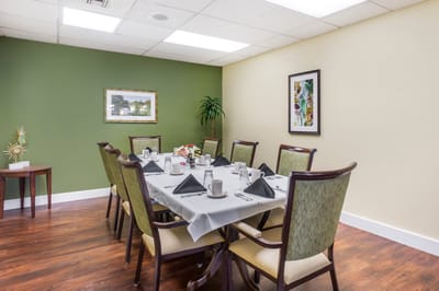 Dining area set up for a meal with tables and chairs