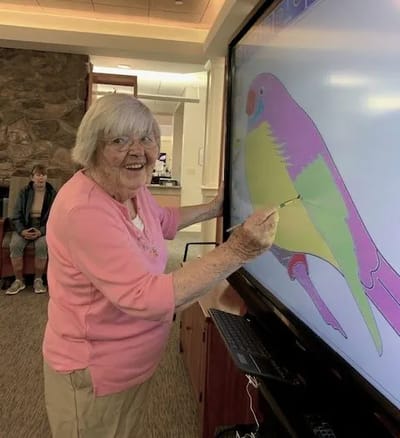 Resident engaging in an art activity on a screen