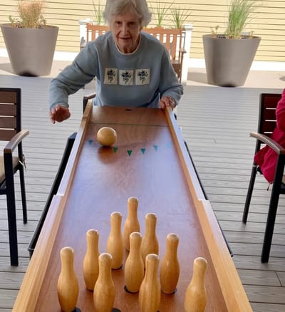Resident playing a bowling game in an activity room