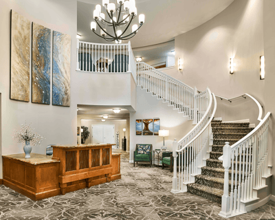 Bright interior lobby with staircase and decorative art