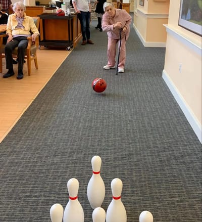 Residents participating in an indoor bowling activity