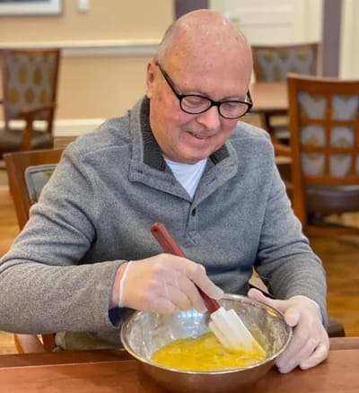 Resident mixing ingredients in a kitchen activity