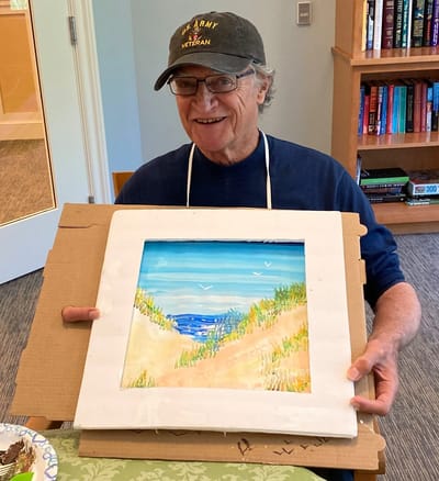 Resident displaying their artwork in a common area