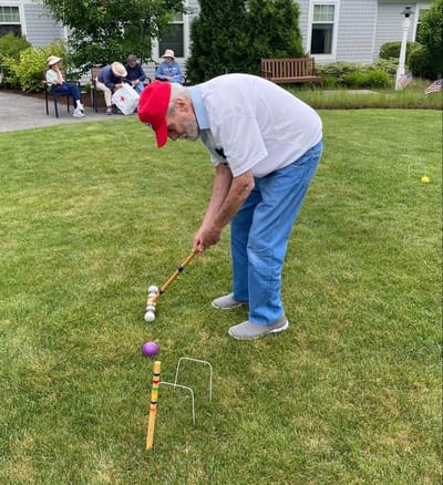 Resident playing croquet in the garden
