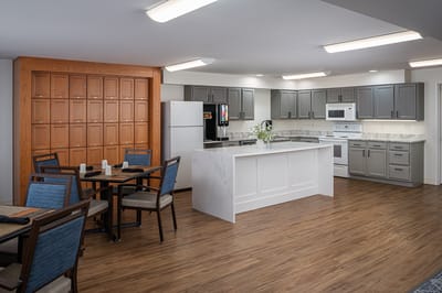 Bright dining room area with kitchen and seating