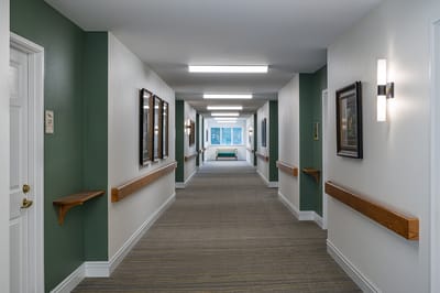 A well-lit corridor in a senior care facility.