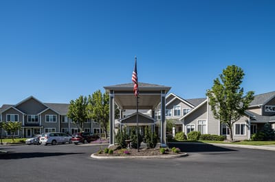 Exterior view of the facility with landscaping and flag
