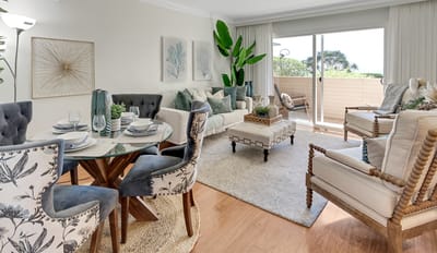 Bright interior living space with dining area and greenery