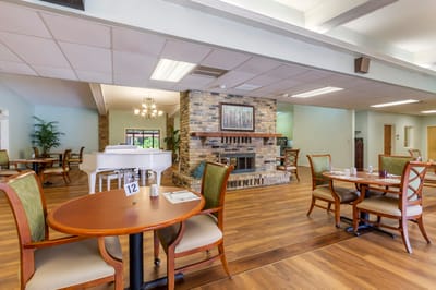 Dining area with wooden tables and a piano