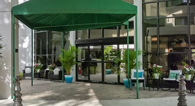 Entrance with greenery and seating area