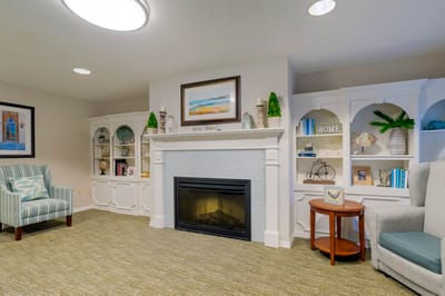 Cozy common area with fireplace and decorative shelves