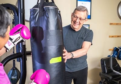 Residents engaging in a fitness activity with boxing equipment