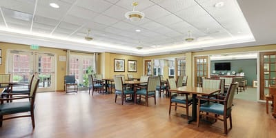 Bright and spacious common area with tables and chairs