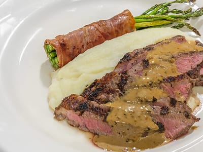Plated meal with steak, asparagus, and mashed potatoes