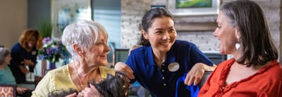 Staff interacting with residents in an activity room