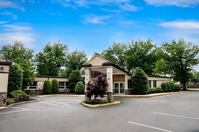 Exterior view of the senior living facility with landscaped entrance