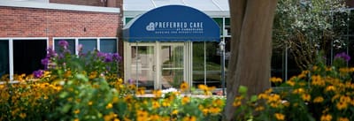 Entrance of Preferred Care at Cumberland surrounded by flowers