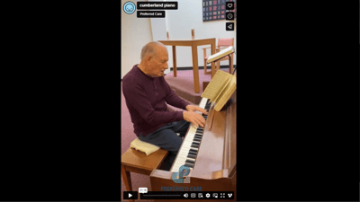 Resident playing the piano in a communal space.