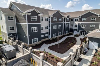 Aerial view of a senior living facility building and garden