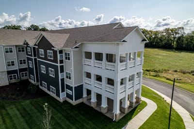 Exterior view of a senior living facility with green space