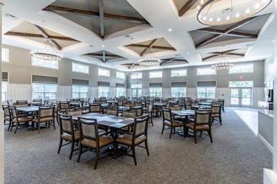 Dining area with tables and chairs in a bright room